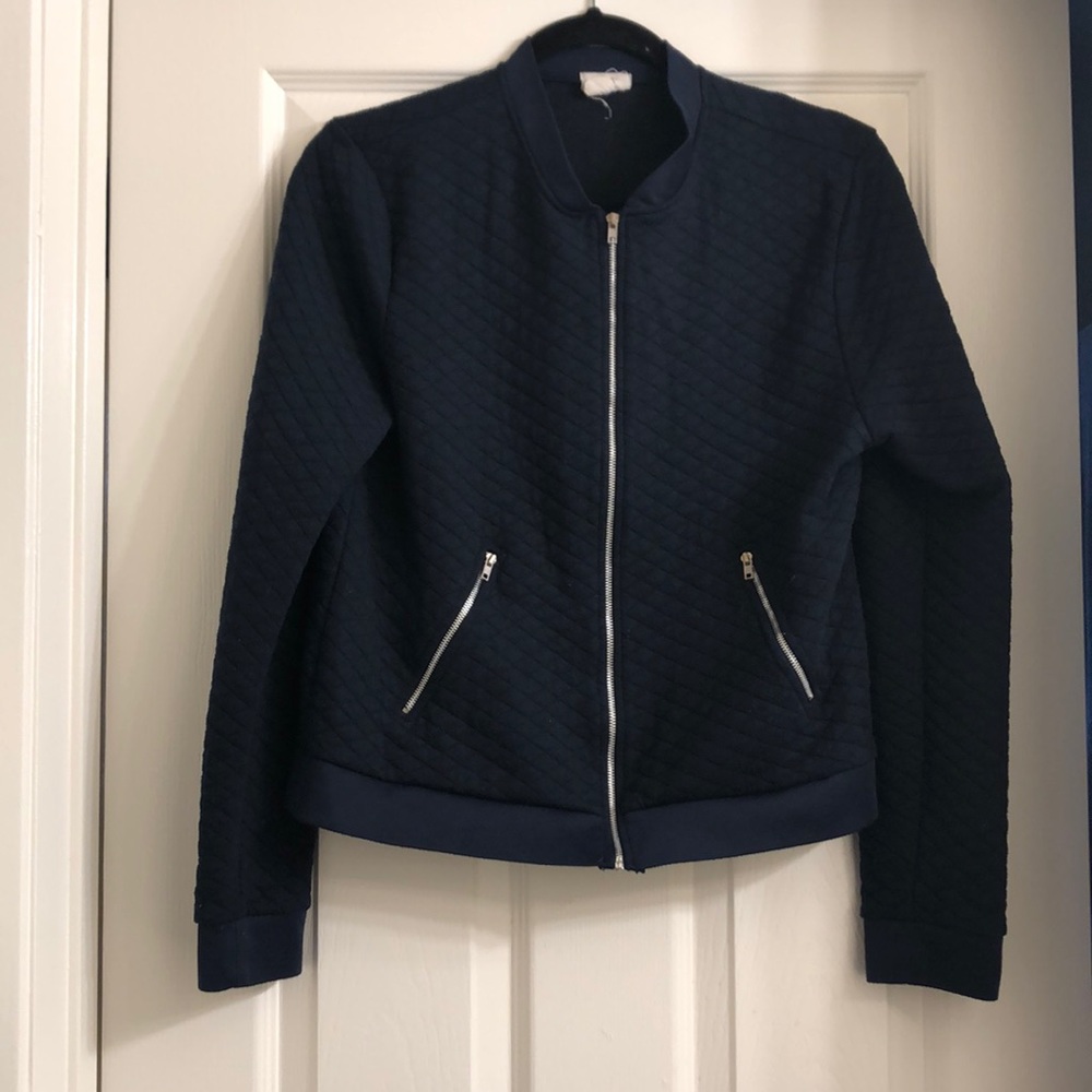 Navy blue baseball like sweater with silver hardware.